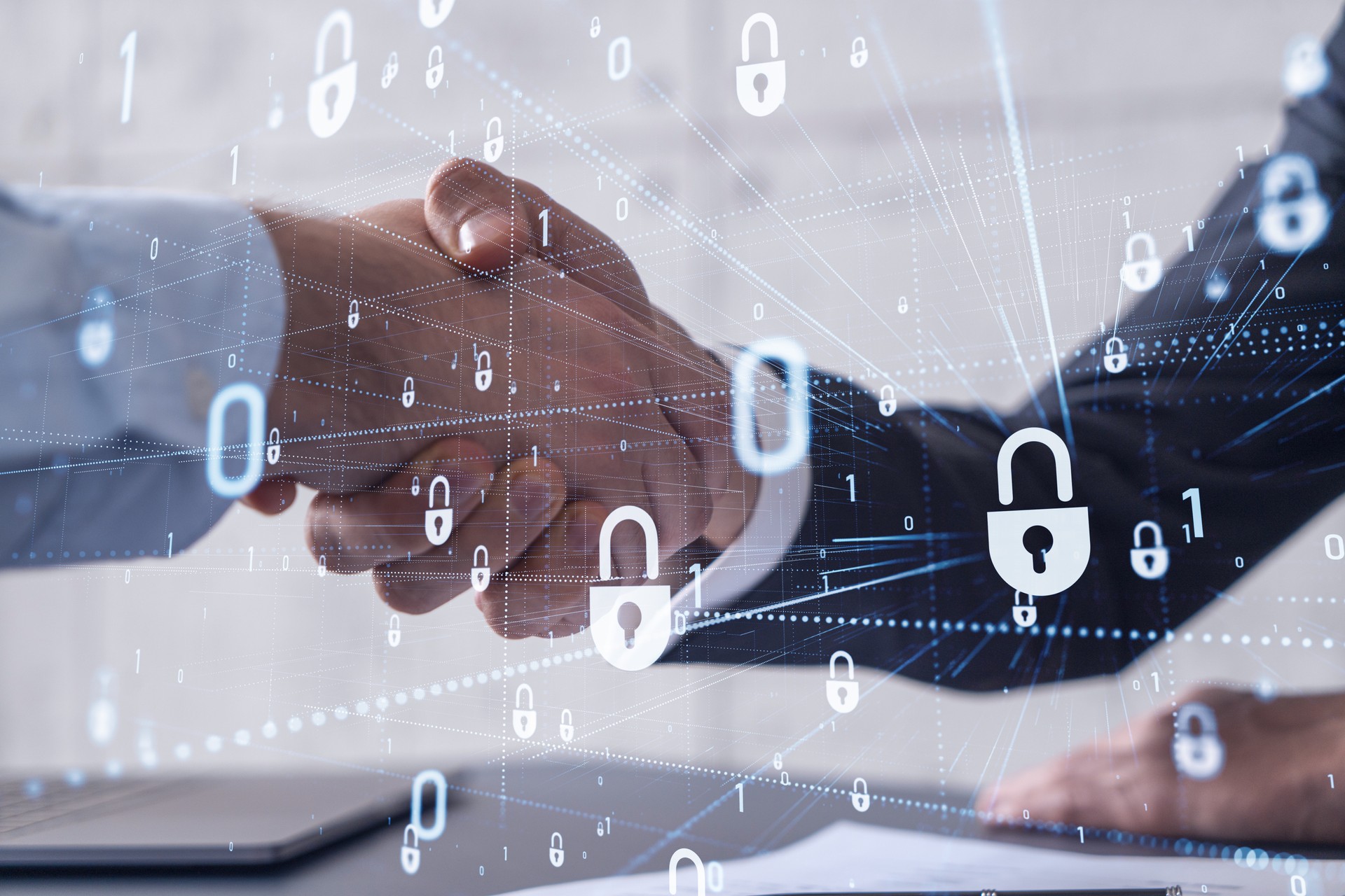 Handshake of two businessmen who enters into the contract to protect cyber security of international company. Padlock Hologram icons over the table with documents.